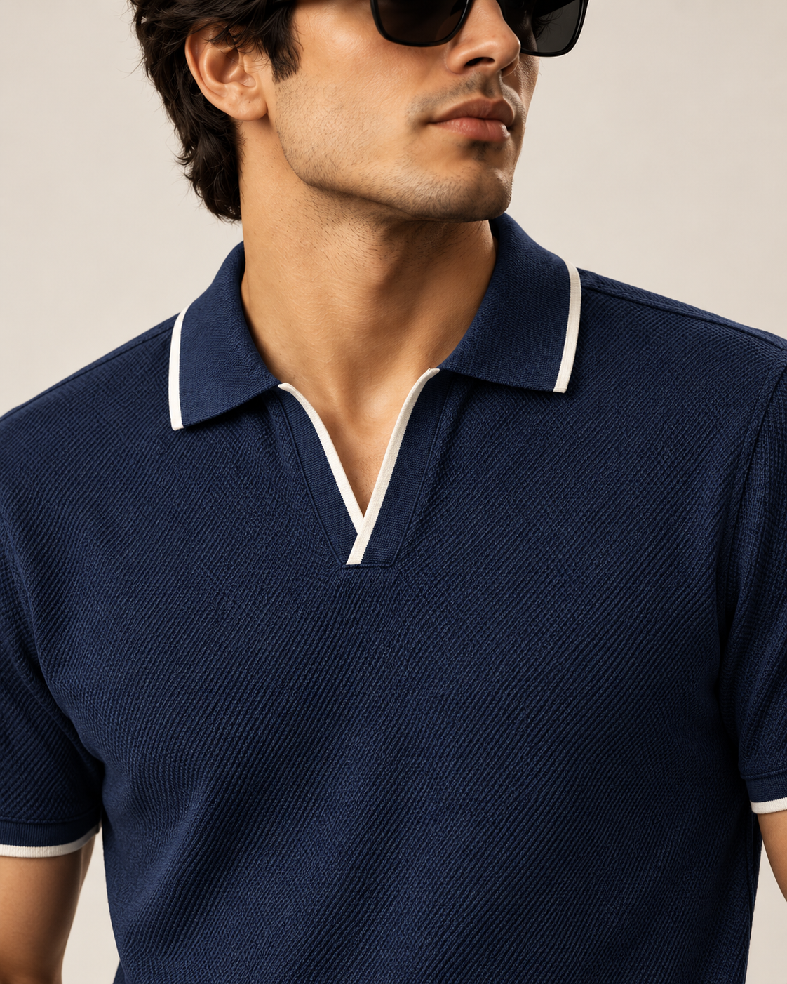 Navy piqué polo open V neckline and white contrast tipping — detail